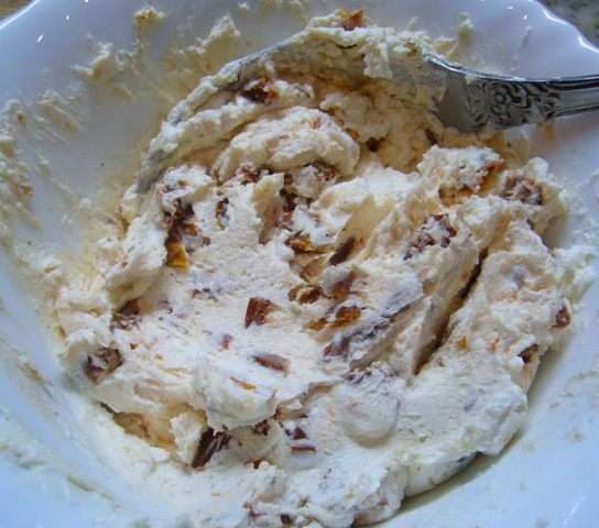 Сливочный сыр смешать с нарезанными вялеными томатами. Добавить по вкусу соль и свежемолотый черный перец. Сырную массу выложить в кондитерский мешок.