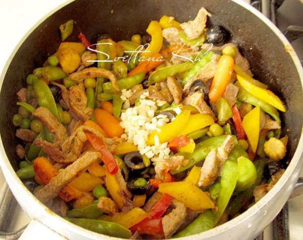 Раздавить зубчик чеснока, мелко изрубить и добавить к мясу с овощами.