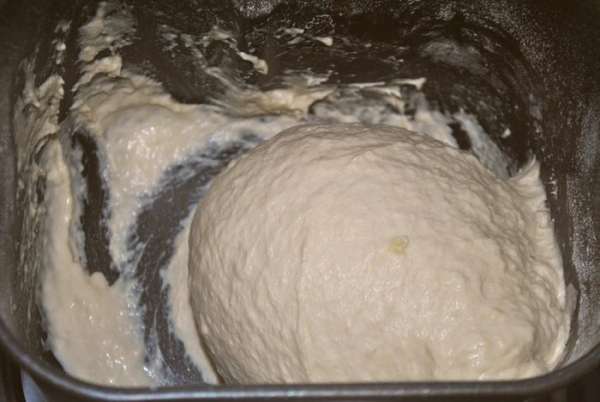 Смешиваем закваску с теплым картофельным отваром и загружаем ее в хлебопечку. Добавляем картофельное пюре, оливковое масло, сахар, соль. Взвешиваем пшеничную муку, но всю сразу не насыпаем, так как ее может уйти меньше или больше. Включаем хлебопечку на программу тесто, по окончании программы дать тесту постоять 1-2 часа до увеличения в 2 раза.
