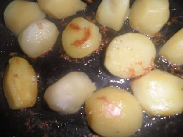 Картофель разрезать пополам,посолить,поперчить и обжарить на подсолнечном масле на сильно разогретой сковороде до золотистого цвета.


