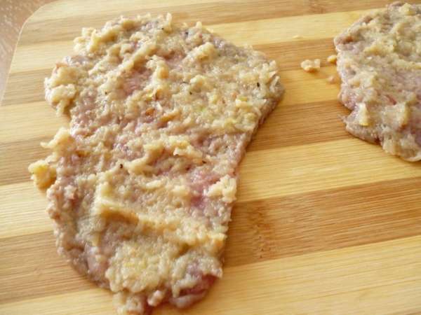 Говяжью вырезку нарезать поперек волокон как для  отбивных,кусочками толщиной 1 см.Хорошо отбить их с двух сторон потоньше.Теперь наносим  слой приготовленной смеси.