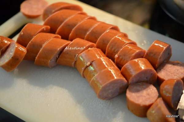 Колбасу порезать кольцами.
